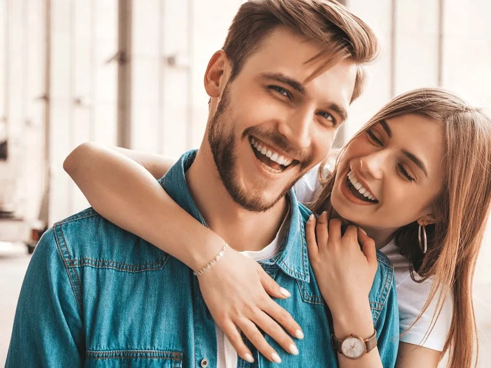 Young couple embracing and smiling