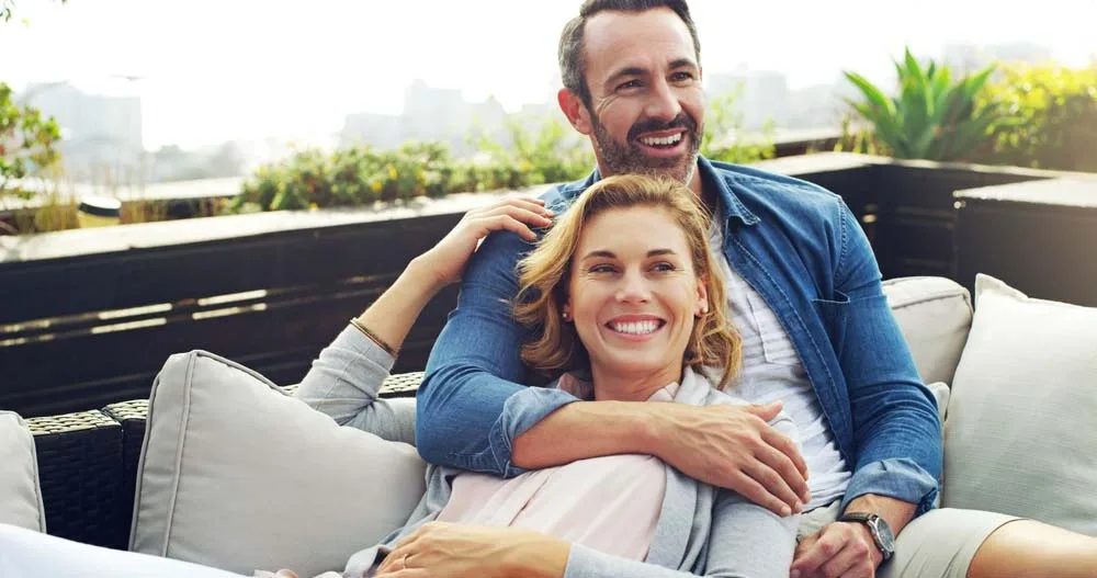 Smiling mature couple relaxing together on a couch