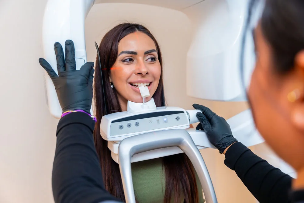 Dentist using a digital scanning device during a patient exam