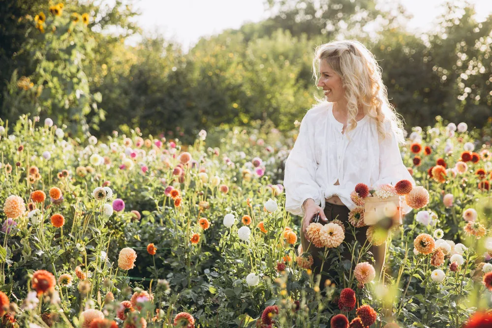Smiling woman standing outdoors in a flower garden