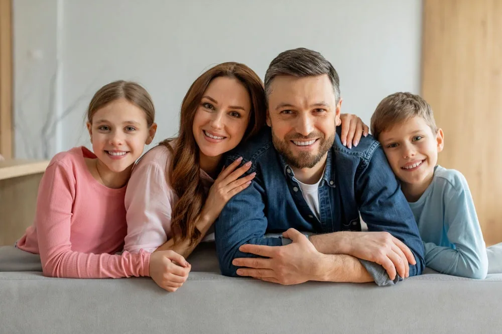 Smiling Family Smiling family of four relaxing together on a couch